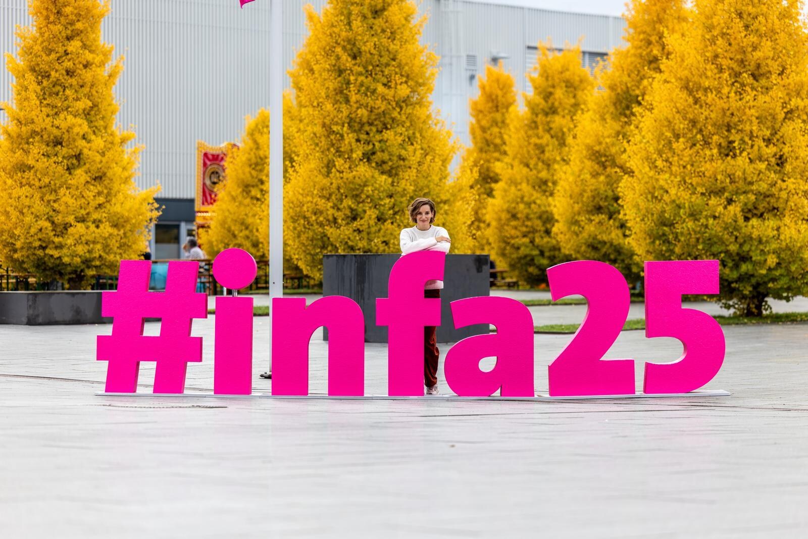 The words “Hashtag infa 2025” are written in large 3D letters at the exhibition center.